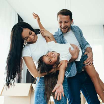 a group of people in a living room with boxes