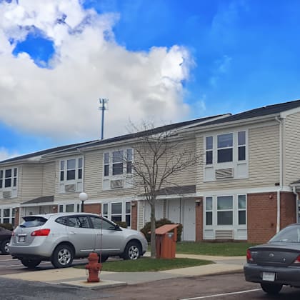 an apartment building with cars parked in front of it