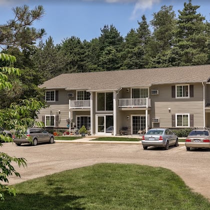 a large house with cars parked in front of it