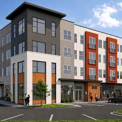 a modern apartment complex with a mix of red, gray, and black colors.