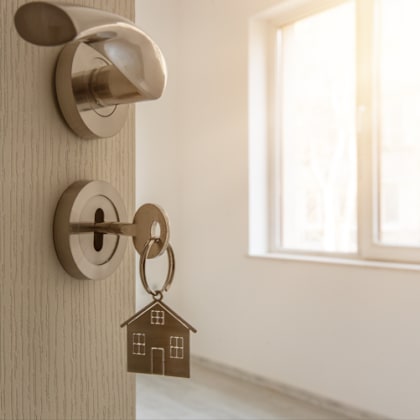 a door with a keychain with a house shaped door knob on it