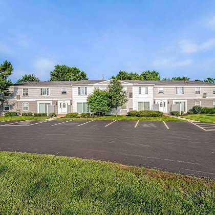 a large building with a parking lot in front of it.
