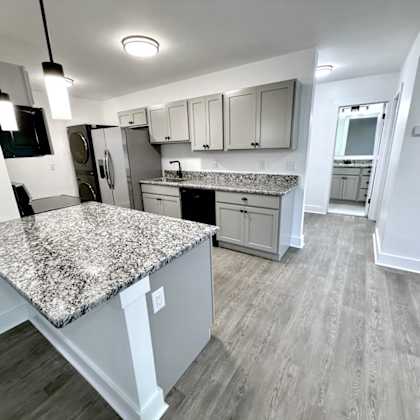 a kitchen with a granite countertop and wooden flooring old green place apartments, beachwood, oh