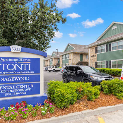 a blue and white sign for tonti apartment homes in sagewood rental center.