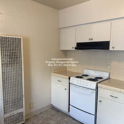 a kitchen with white appliances and cabinets.