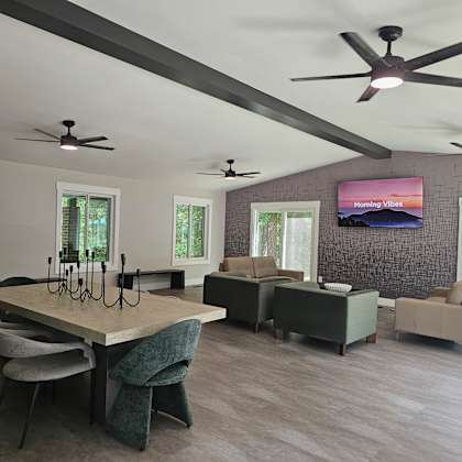 a modern living room with a large table and chairs.