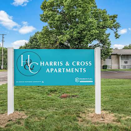 a sign in front of a building that says harris & cross apartments