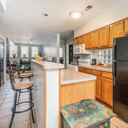 a kitchen with a long counter and stools