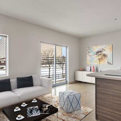 a living room with a white couch and a black coffee table