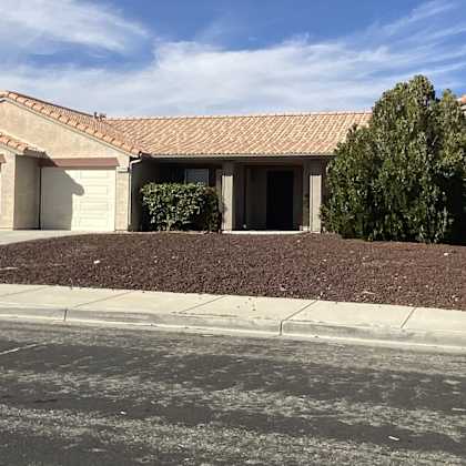 a house with a driveway and a sidewalk in front of it