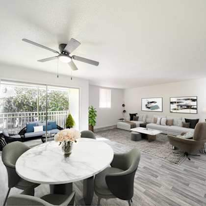 a living room with a white ceiling fan and grey chairs. at red bay apartment complex, jacksonville, fl, 32211