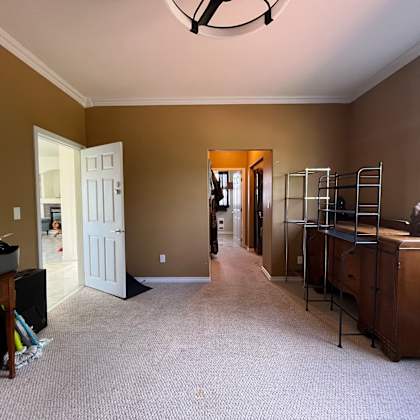 a room with a brown wall and a white door.