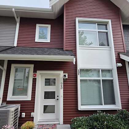 a house with a red siding and white trim.