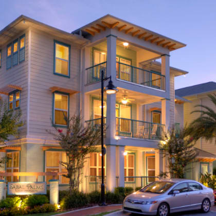 a large building with cars parked in front of it