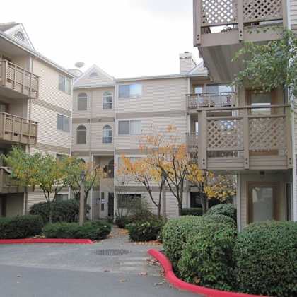 a parking lot in front of an apartment building