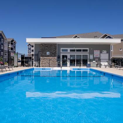 a large blue swimming pool in front of a building.