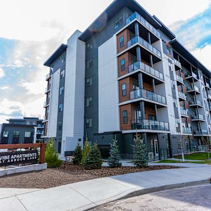 a large apartment building at vibe apartments at arbour lake, alberta