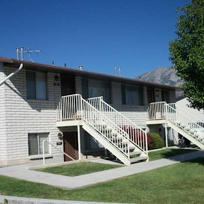 a building with a staircase leading to the front door.