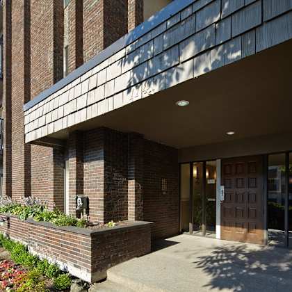 a large brick building with glass windows and doors