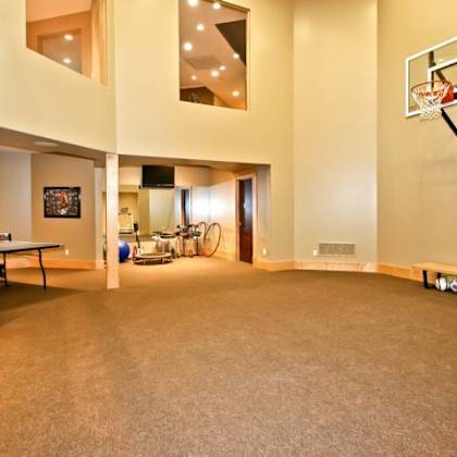 a basketball hoop is mounted on a wall in a spacious room.