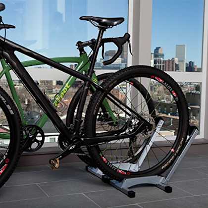 a bike on a stand in front of a window