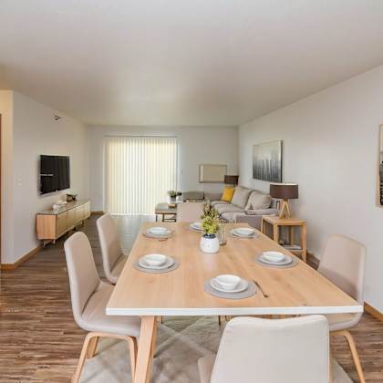 a dining room with a long table set for six people.