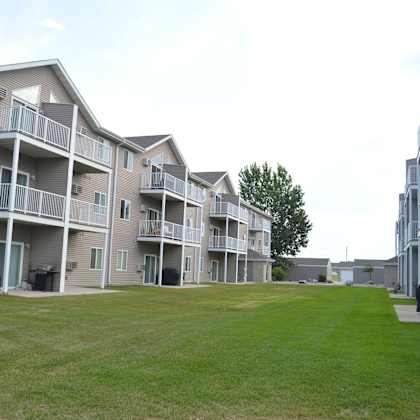 apartment complex with a green lawn in front.