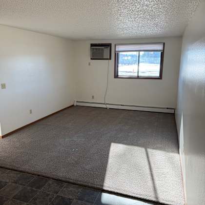 a room with a window and a tiled wall.