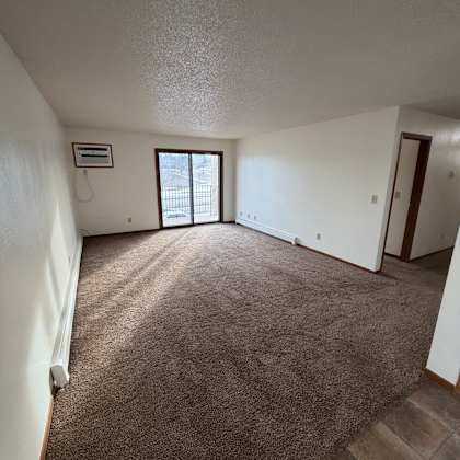a room with a window and a brown wall.