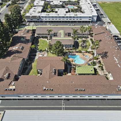 a large building with a parking lot in front of it.