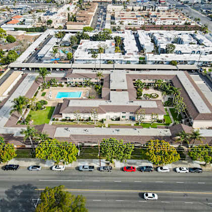 a large building with a pool in the middle of a grassy area.