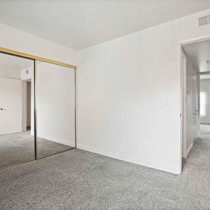 a room with a carpeted floor and a glass door.