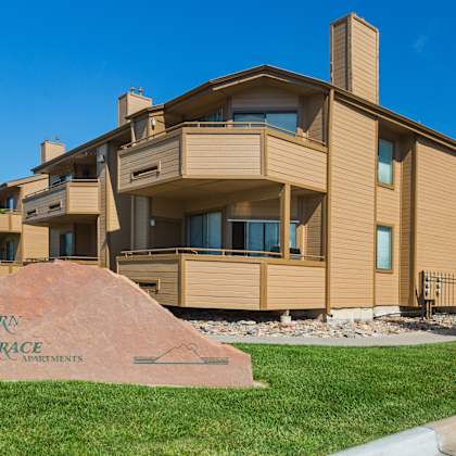 a large house with a sign in front that says western terrace apartments.