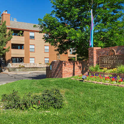 a brick sign that says winridge in front of a building.