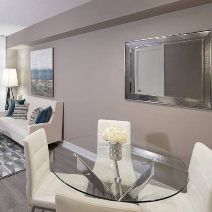 a living room filled with furniture and a large mirror