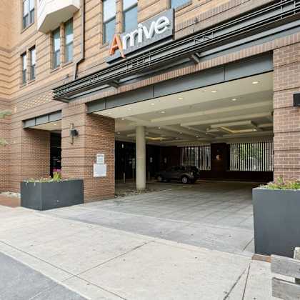 a large brick building with an entrance and a sign on the side