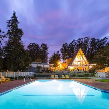 pool view with the main cabin in the background at salinas sunset apartments, salinas, ca, 93907