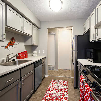 full kitchen with stainless steel appliances at the district flats apartments in lenexa