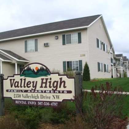 a sign for valley high family apartments is in front of a building.