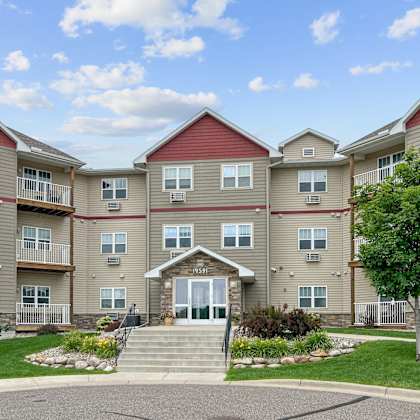 an exterior view of an apartment building with stairs