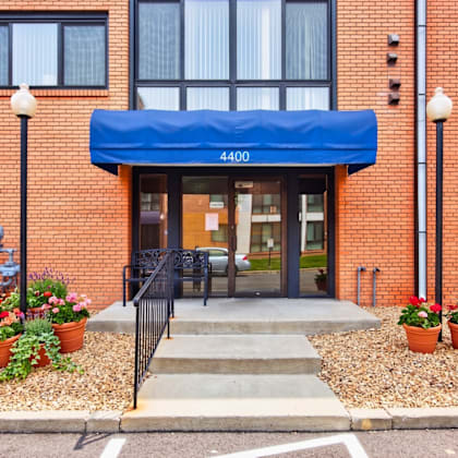 the front of a building with a blue awning and the number 4400 on it.