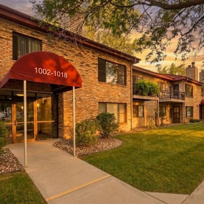 the image shows a building with a red awning that has the numbers 1002-1018 on it.