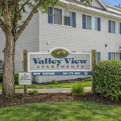 a sign for valley view apartments is displayed in front of a building.