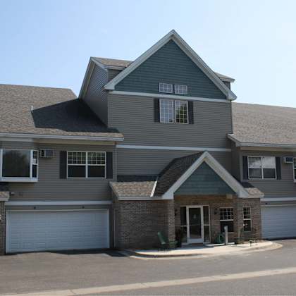 a large house with a grey roof and a white garage door.