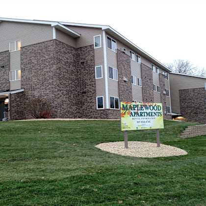 a sign in front of a building that says "matewood apartments".
