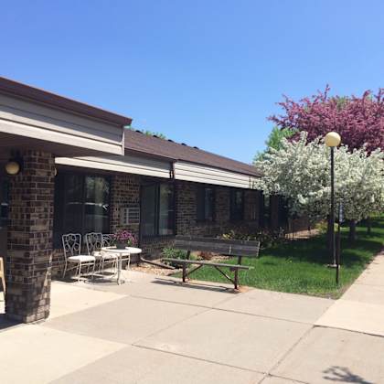 a building with a patio and a bench.