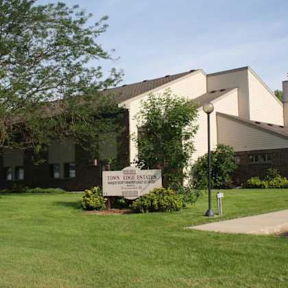 a sign in front of a building that says town edge estates.