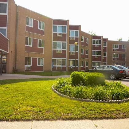 a large grassy area in front of apartment buildings.