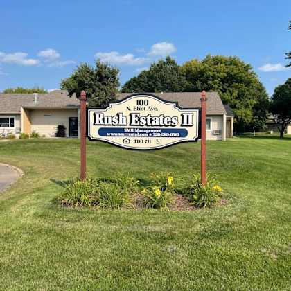 a sign for rush estates ii is shown in front of a building.