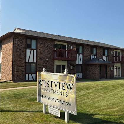 a brick building with a sign that says westview apartments.